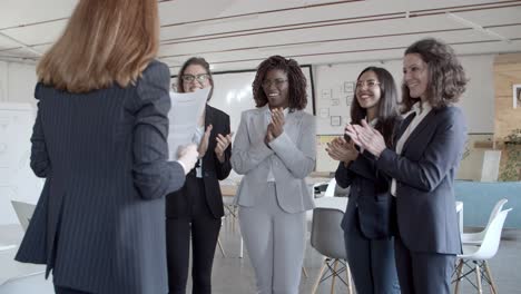 businesswomen applauding to female colleague