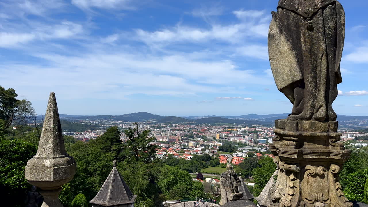 Rocky Statue on top of Bom Jesus do Monte Cathedral with cityscape view of Braga, Portugal - Wide shot