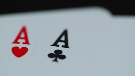 A-close-up-macro-shot-of-playing-cards-with-all-four-aces-hearths-diamonds-space-cross-lying-on-an-elephant-while-moving-as-the-cards-slowly-expose-from-the-side