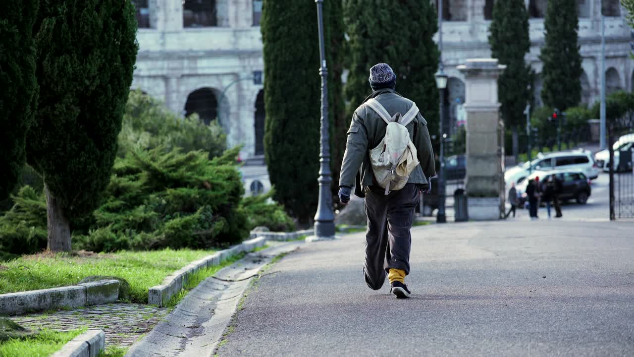 고독한 노숙자가 로마의 거리를 고 있다.