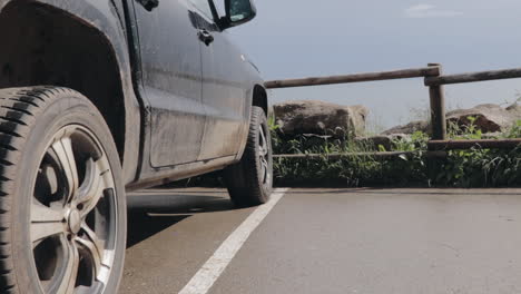 Panning-view-of-dirty-pickup-truck-parked-by-surf-spot-in-slow-motion