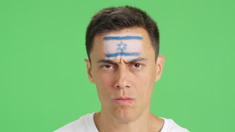 serious man with a israeli flag painted on the face