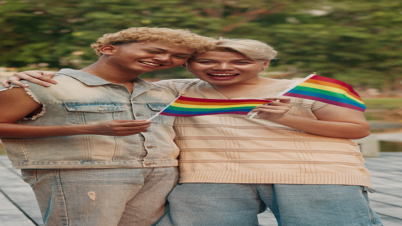 Two Smiling People Holding Rainbow Flags