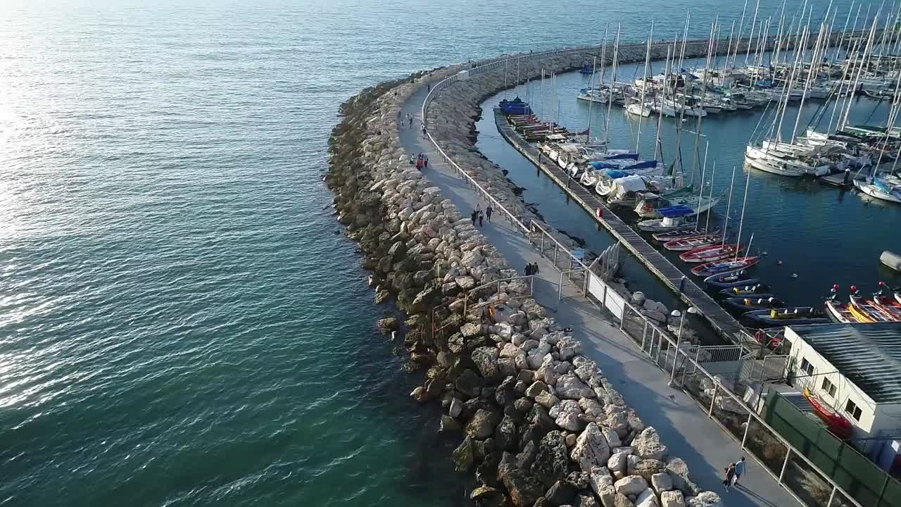 A view of a marina with many boats docked.