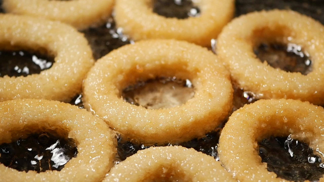 Golden Onion Rings Frying in Hot Oil, Close-Up