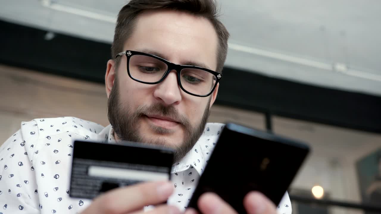 hombre hacer pago en línea por teléfono tarjeta bancaria de crédito