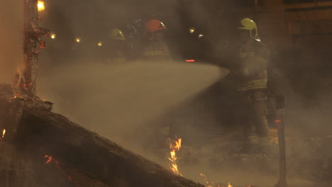 firemen fighting fire with water