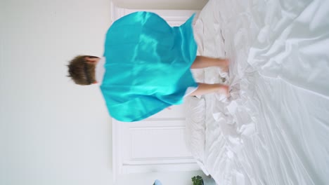 Superhero-boy-jumping-on-the-bed