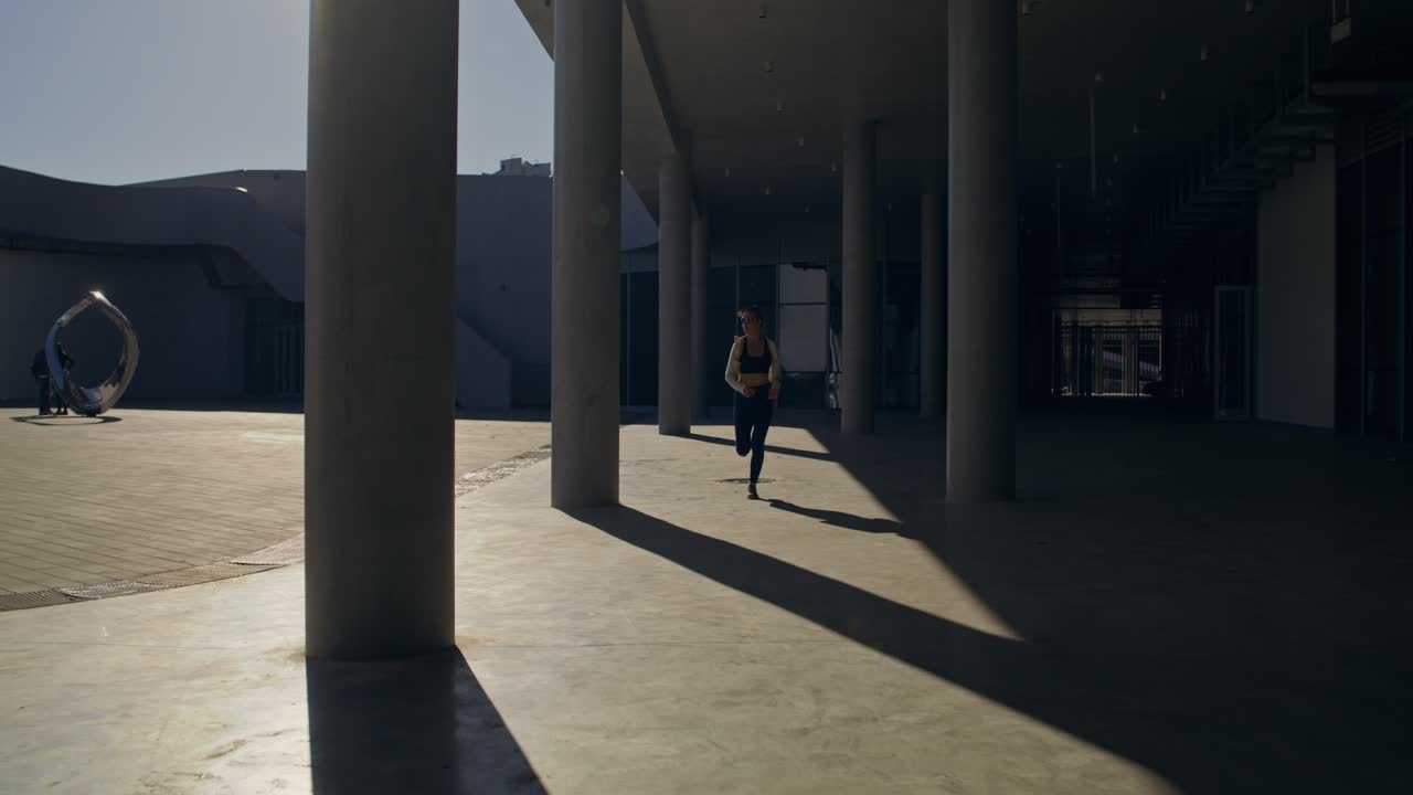 Woman running in a modern architectural setting