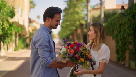 man gives woman a bouquet of flowers