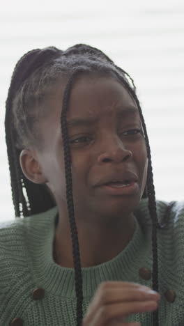 vertical video of sad african american teenage girl crying in slow motion