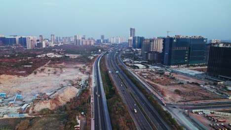 concrete mining with solar cycle track, service road and orr at nanakramguda, financial district, hyderabad, telangana, india. day time, push in, drone shot, 4k.