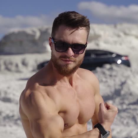 bodybuilder posing on nature