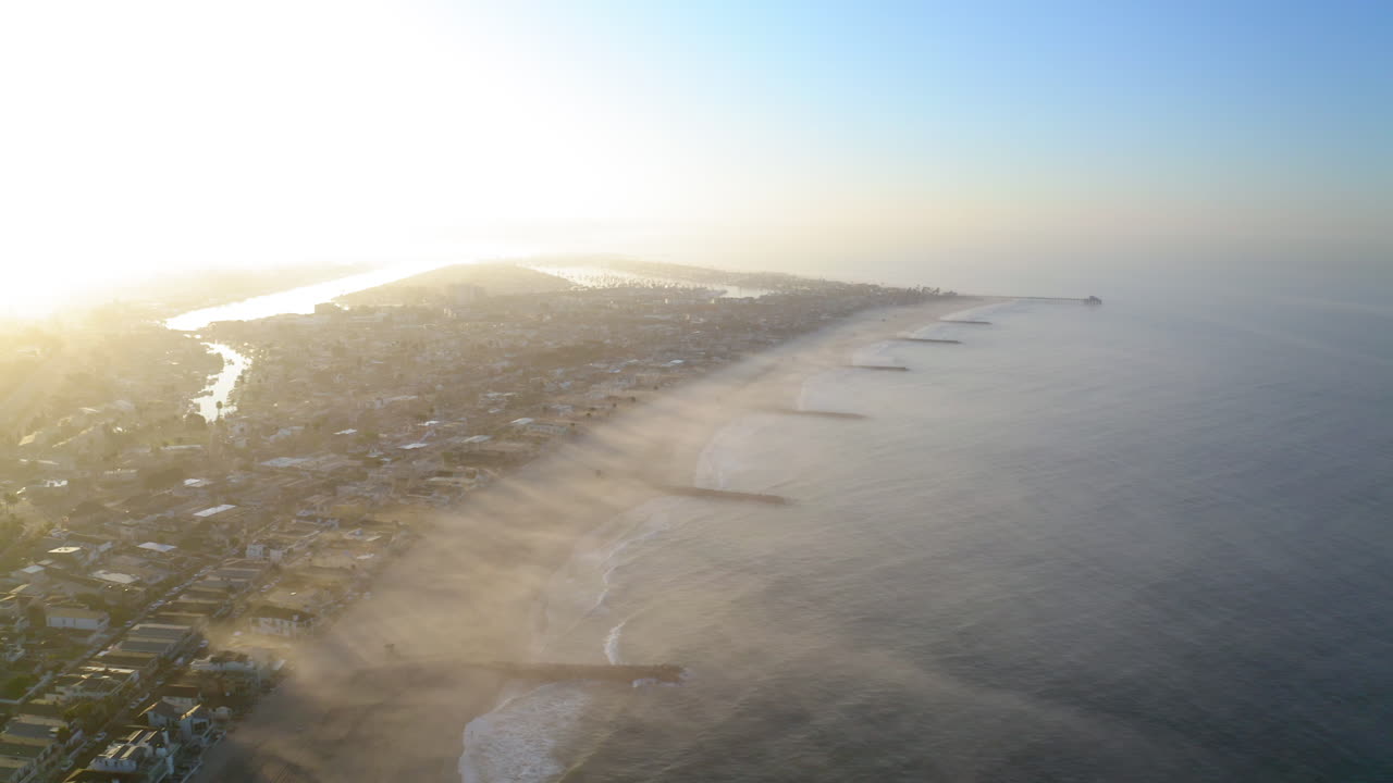 Aerial View of a Coastal City with Beach and River at Sunrise or Sunset