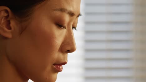 a woman sits thoughtfully, lost in her thoughts as soft afternoon light filters through the window. the peaceful moment captures her introspective expression and serene atmosphere.