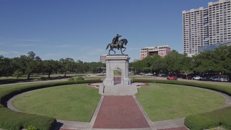 aerial - low shot of sam houston statue and reveal of background - houston, tx