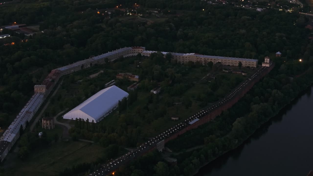 Aerial cinematic footage of historic Modlin Fortress illuminated at dusk
