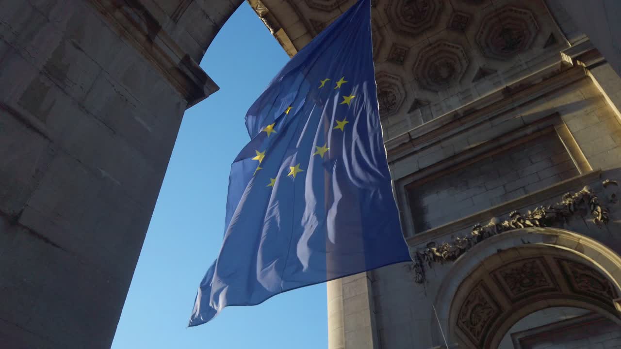 European Union flag waves beneath Cinquantenaire Arch