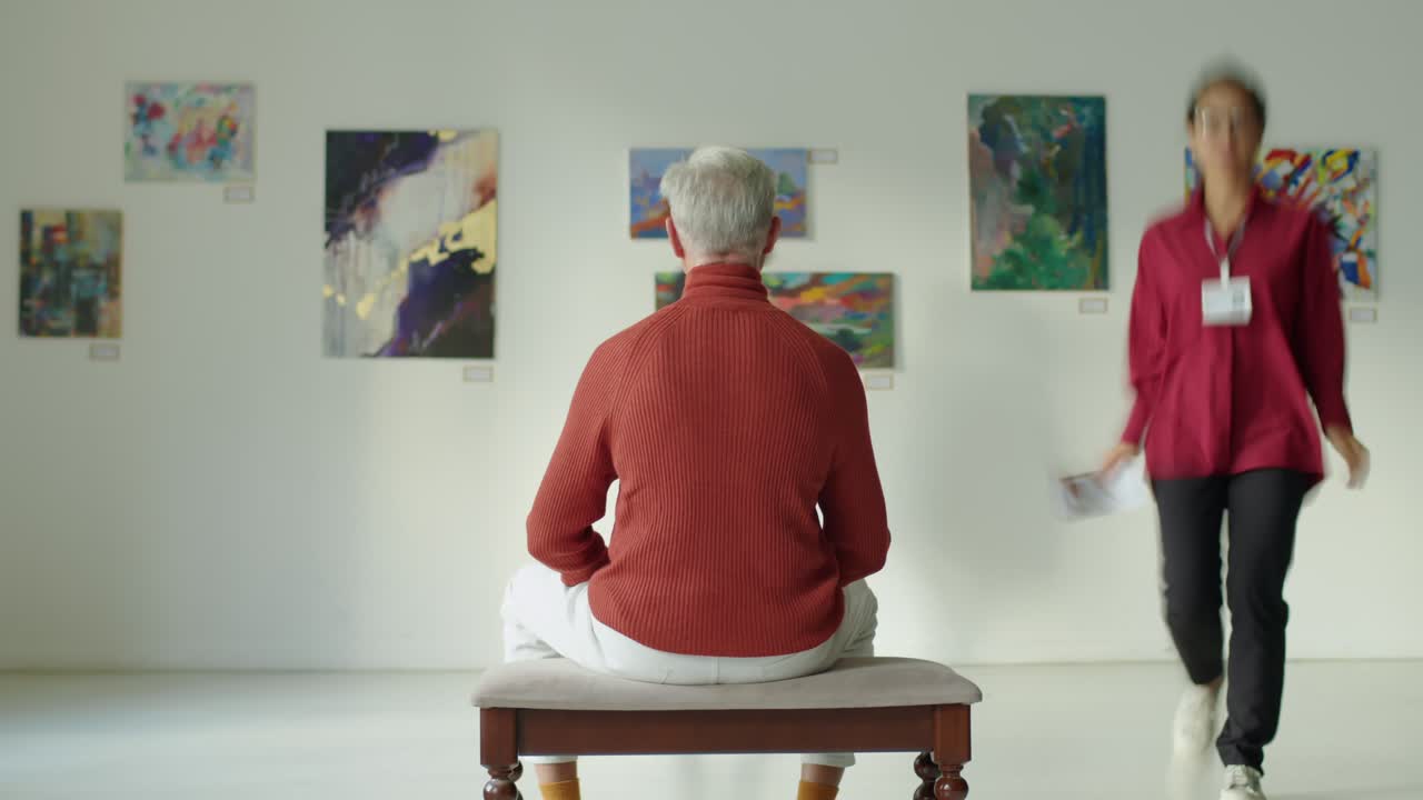 Timelapse of Man Sitting in Art Gallery