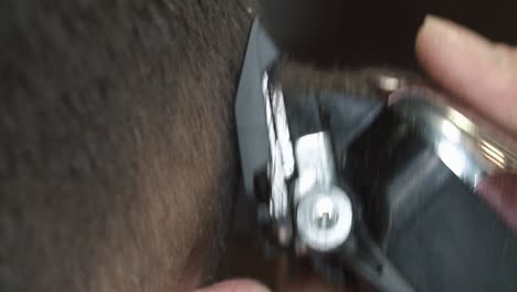 close-up of hair clippers during a haircut