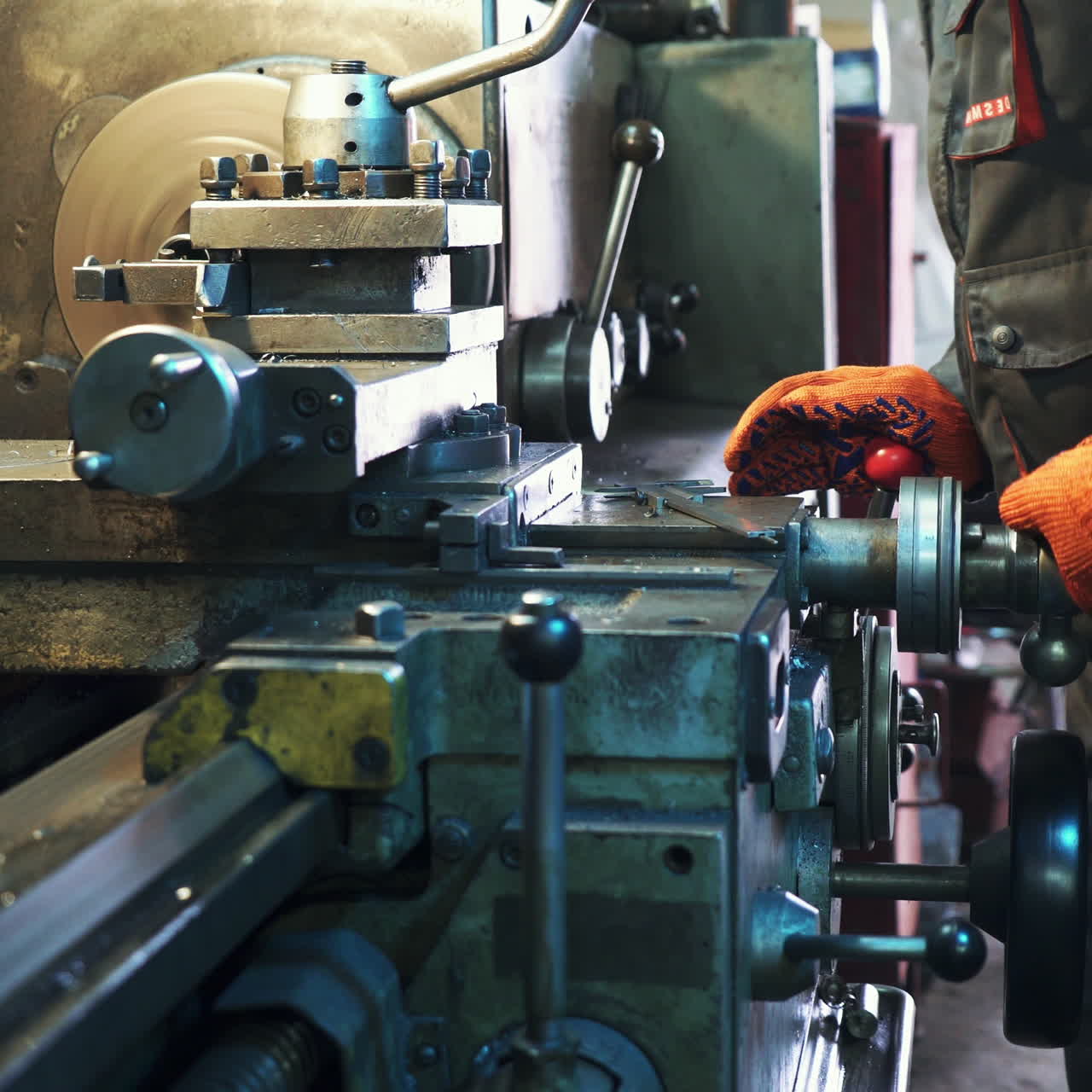 Young mechanic working on a lathe. Metalworking industry. Square video