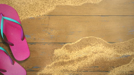 Closeup-sandy-beach-with-sandal-on-wood-2