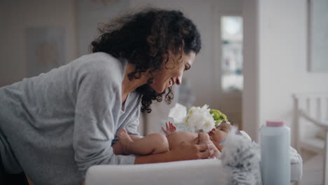 mother caring for baby on changing table happy mom playfully soothing toddler nurturing her child at home 4k footage