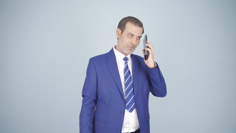 Businessman-getting-interrupted-and-angry-while-talking-on-the-phone.