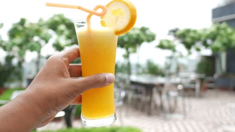 Glass-of-orange-juice-outdoor-,