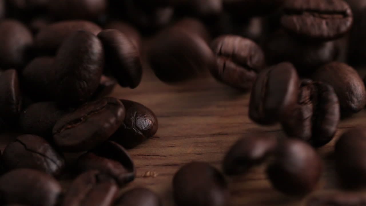 granos de café derramados sobre una superficie de madera
