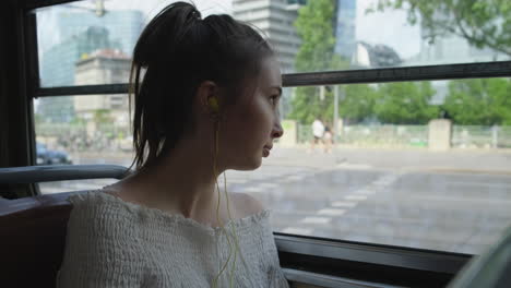 woman looking out of a bus window