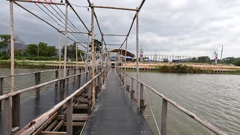 walking across a scenic bamboo bridge