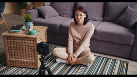 woman recording a vlog at home