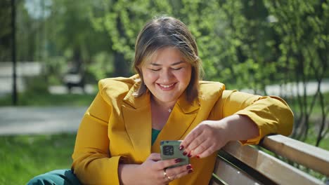 plus-size woman using smartphone in a park