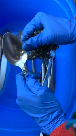 cleaning silverware with gloves