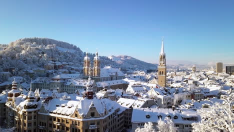 Down-top-aerial-video-of-the-old-town-covered-with-snow,-Sankt-Gallen,-St