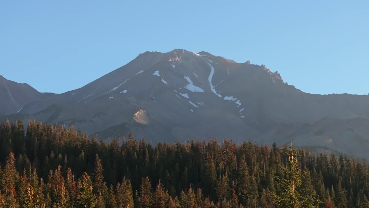 Scenic view of Mt. Shasta with pine trees at sunset, California, USA