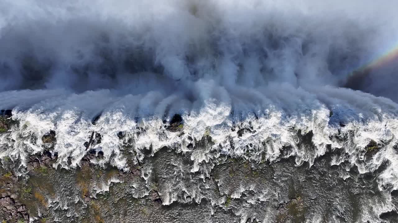 Aerial View of a Majestic Waterfall with a Rainbow