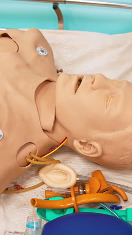dummy model for teaching medical practice. mannequin doll of a man lying in hospital bed in studying room of medical university. vertical video