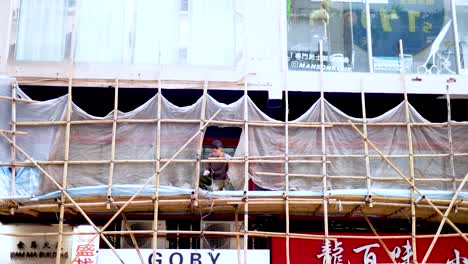 scaffolding and workers repairing a building facade