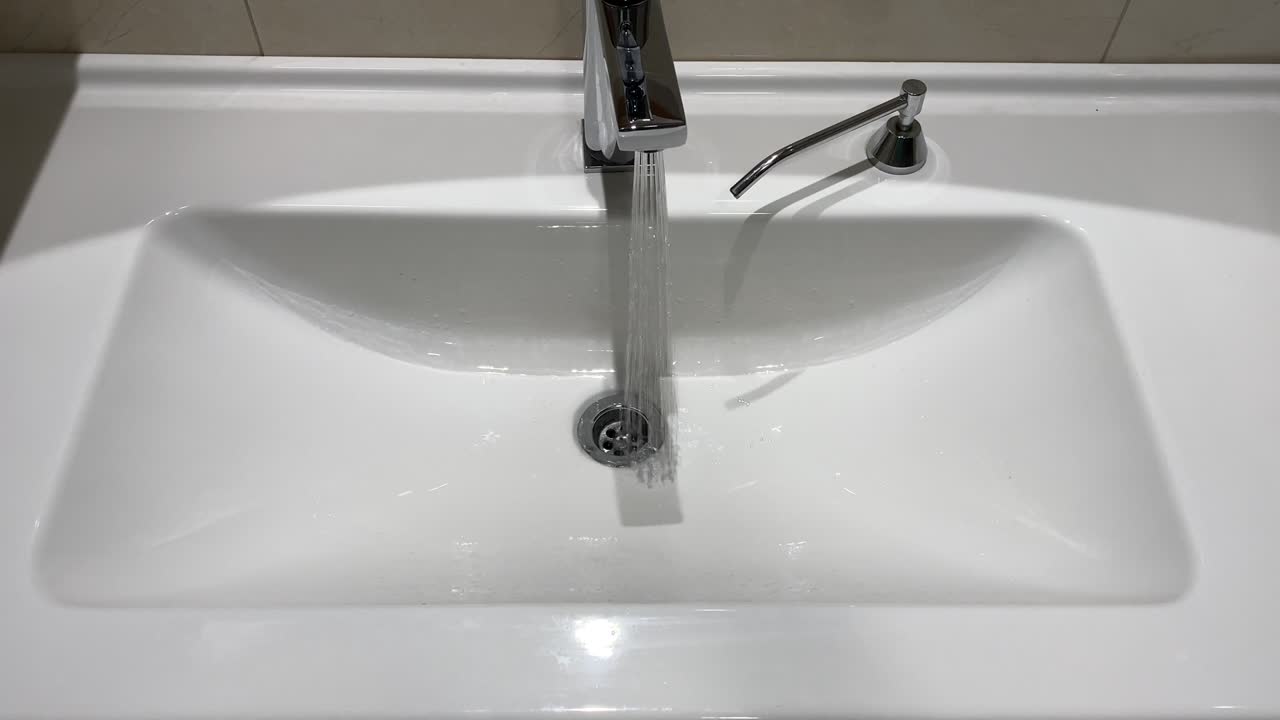 Aerial view of water flowing from the tap