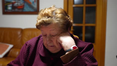 close up portrait of old woman granny talking about health with sos bracelet on