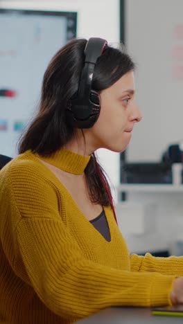 vertical video photo editor with headphones retouching image using stylus pen
