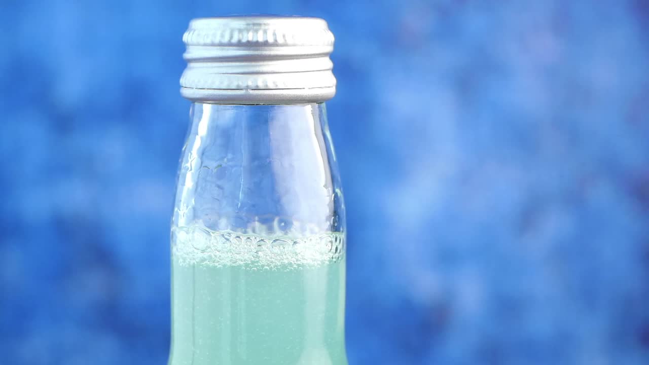 Close-up of a Teal-Colored Soda Bottle