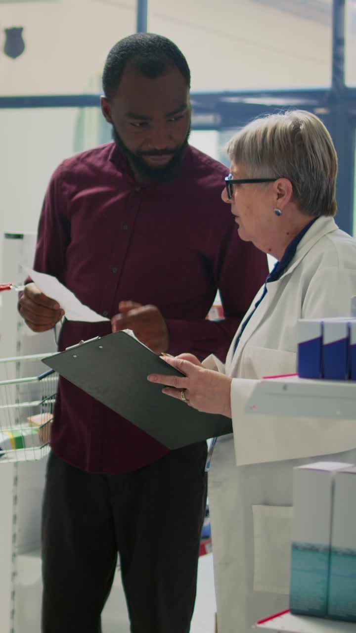 Vertical video: African american client giving prescription paper to pharmacist