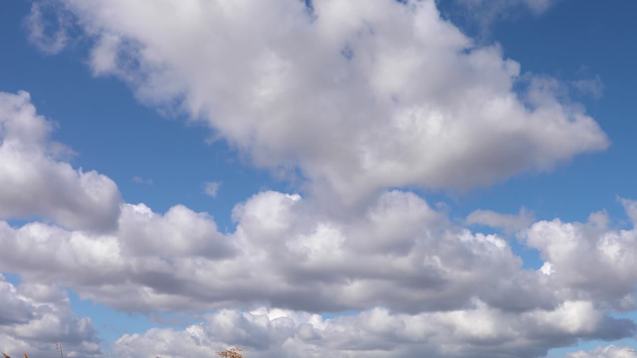 nubes blancas y esponjosas en el cielo azul sobre la costa de suffolk, reino unido