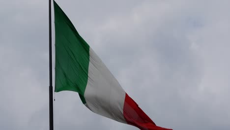 italian flag flying on gloomy day