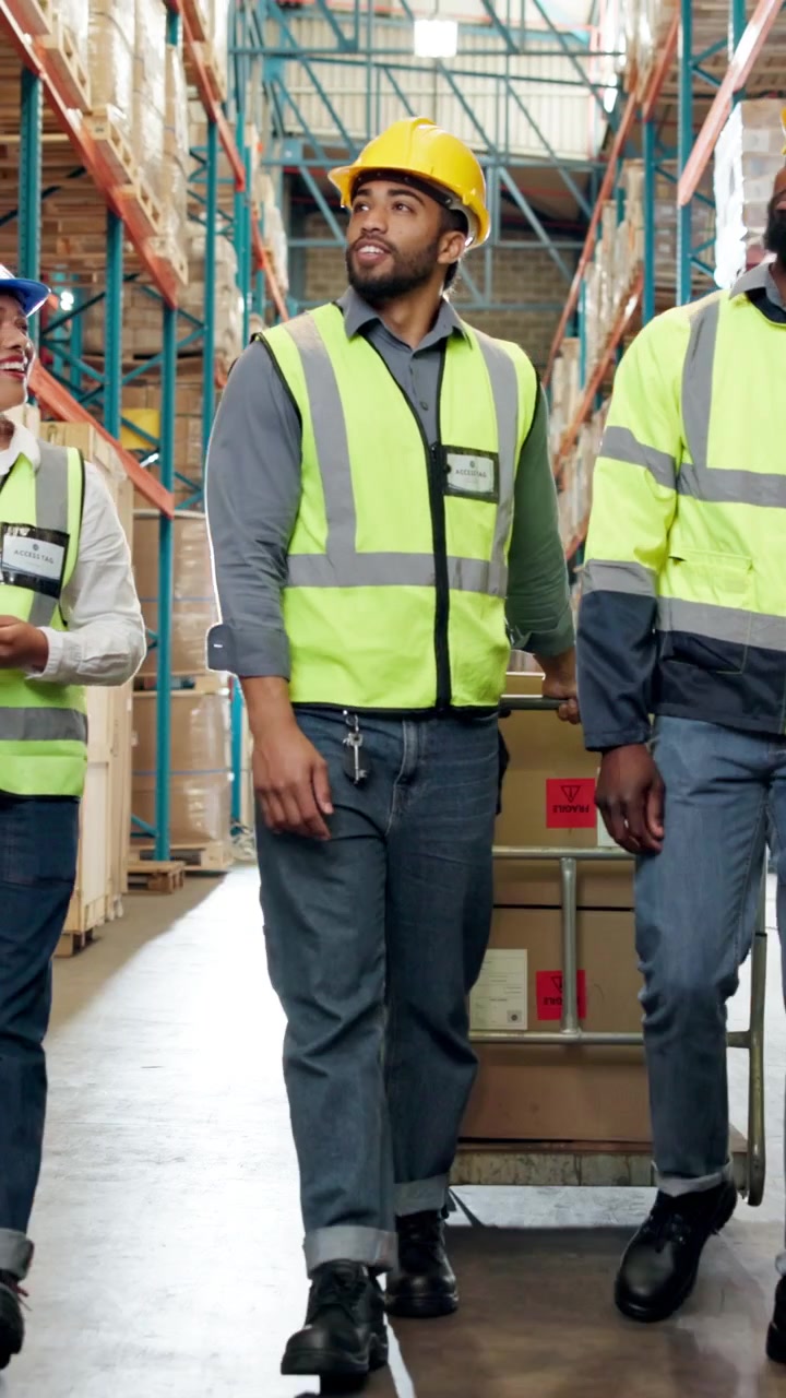 Warehouse Workers Walking and Discussing Logistics in Distribution Center