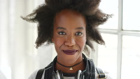 edgy young african woman with stylish afro smiling