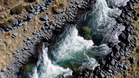 aerial view of river rapids flowing through a rocky landscape